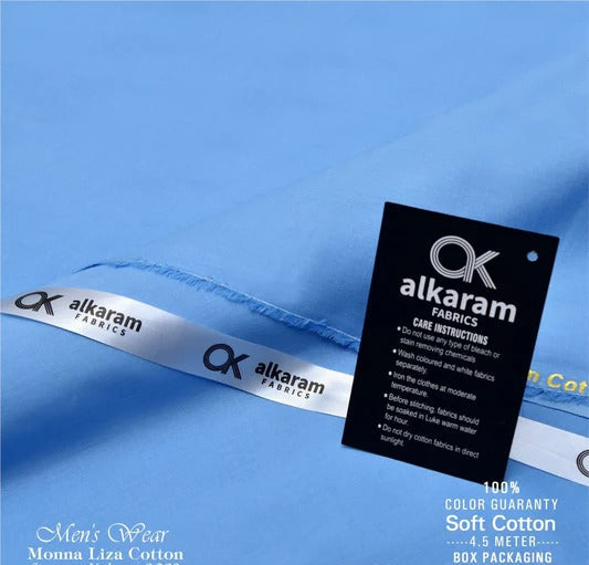 Alkaram Fabrics label on blue fabric with care instructions.